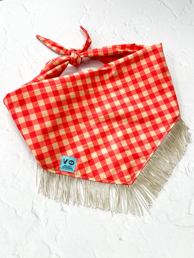 Red and white checkered bandana with fringe on a white background